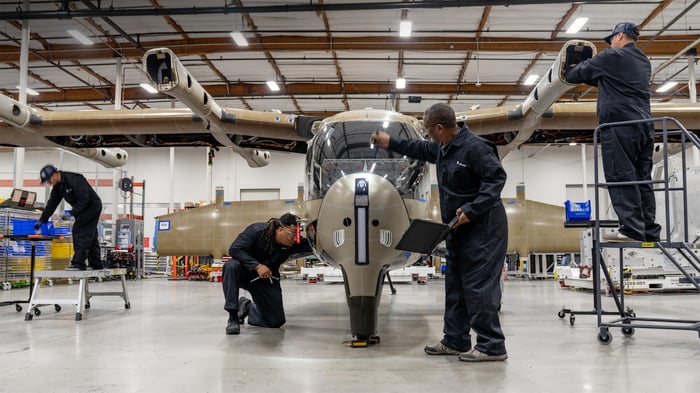 Technicians working on an Archer Aviation Midnight aircraft.