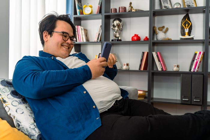 Person plays a mobile game on phone. 