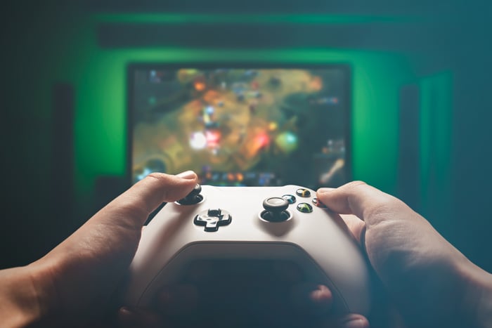 Hands pointing game controller at TV screen.
