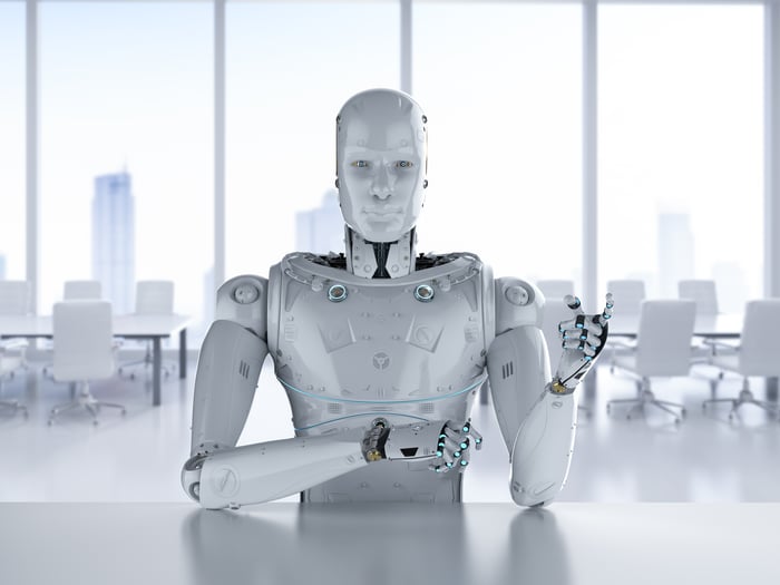 A humanoid robot sitting in an office.