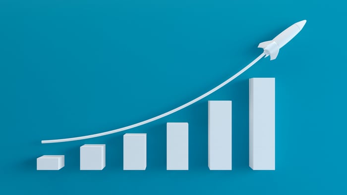A rising bar chart launching a rocket. 