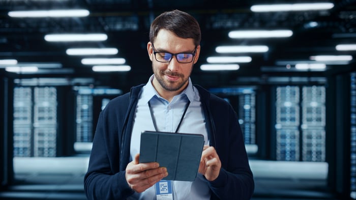 Person working on a tablet in a data center.