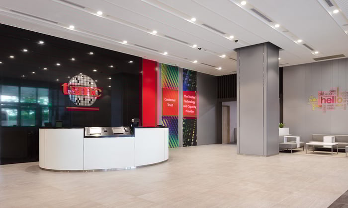 Taiwan Semiconductor office with TSMC logo on the wall.