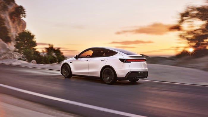A Tesla Model Y speeding down the highway.