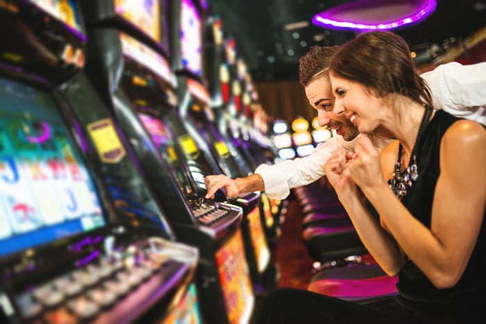 A couple playing at an arcade.