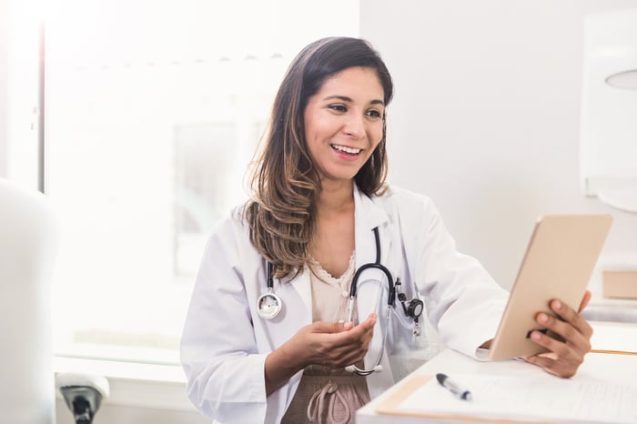 A doctor talking to a patient over a mobile device.