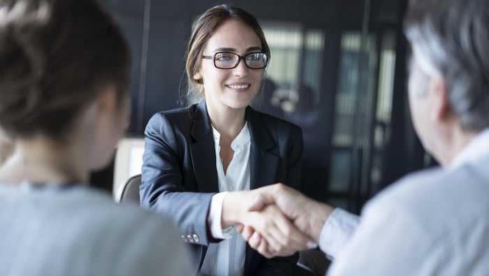 A meeting between a bank lender and two borrowers.
