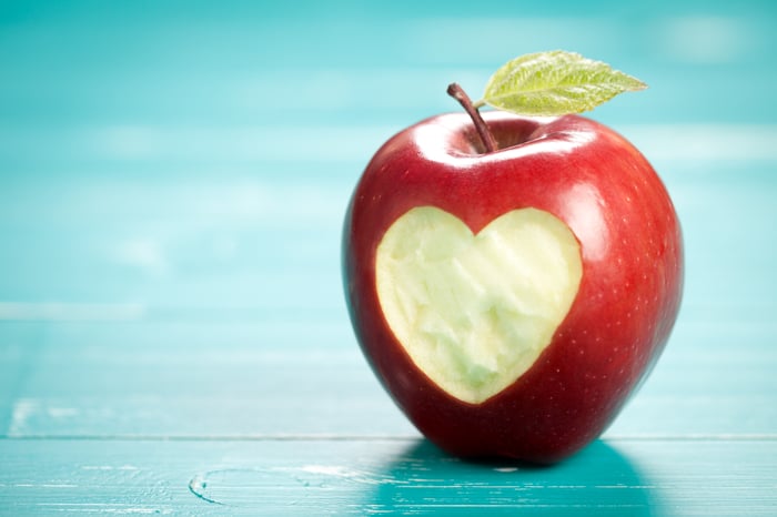 Apple with a heart shape carved in the skin.