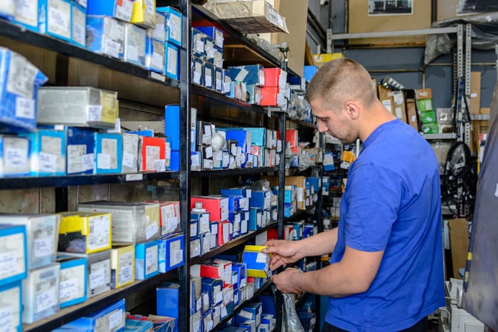 Worker going through auto parts.