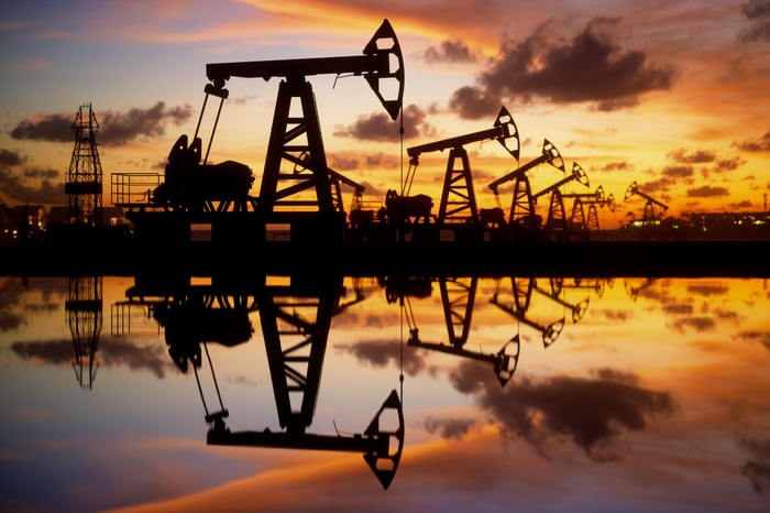 Oil derricks at sunset. 