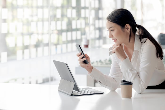 Person looking at a smartphone and a tablet.