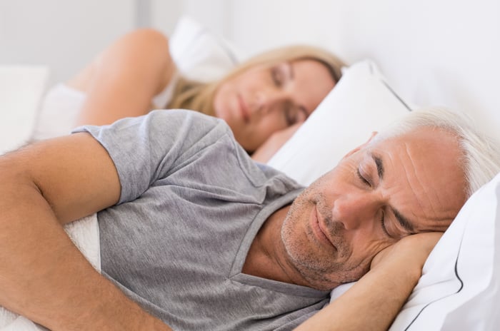 Two people asleep in bed.