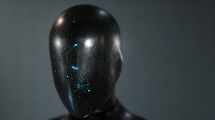 A black robot head with bright blue dots of light on it.