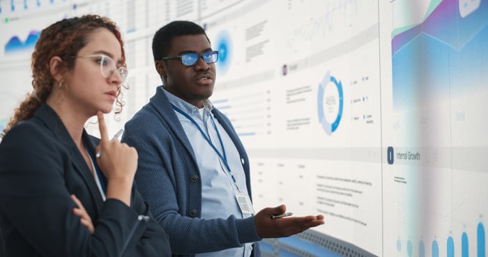 Two people looking at charts.
