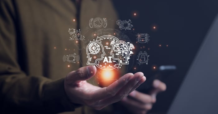 AI and digital images appearing above a burst of light and an outstretched hand.