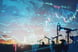 Oil pumps with a price chart in the background.