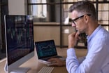 Businessman_studying_stock_charts