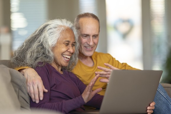 Couple looking at a laptop.