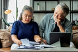 Stressed couple looking at documents together