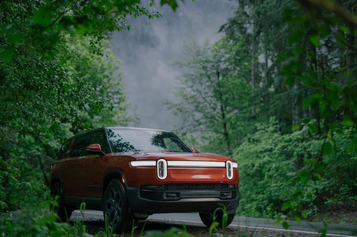 A red SUV in the woods.
