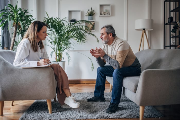 A person talking to a therapist.