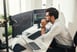 Person sitting at a desk looking at two monitors
