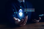 A person's hand cupped open with a hologram of an AI chatbot above saying Hi, can I help you