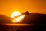 F-35 taking off in front of a sunset. IS LMT