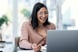 happy investor looks at laptop.
