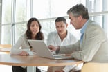 investors discuss investment at table