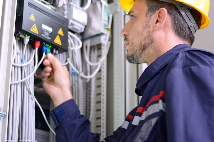 Technician fixing a modem.