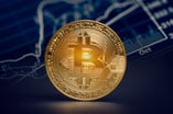 A gold coin with the Bitcoin symbol on its face