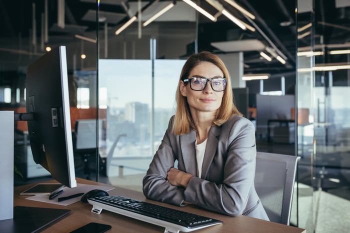 Executive sitting in office at desk and computer.