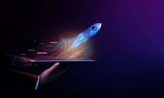 Rocket launches out of a tablet.