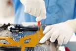 A technician working on semiconductor equipment.