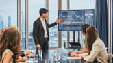 Person giving a presentation involving a stock chart.