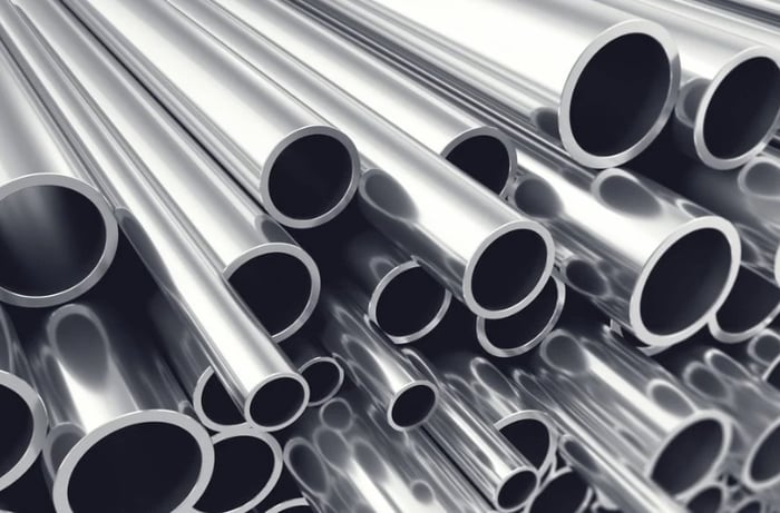 Some silver tubes stacked alongside each other.