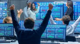 Wall Street traders looking at graphs and charts cheering because the stock market went up