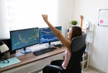 Person looking at graphs and charts happy because the stock market went up