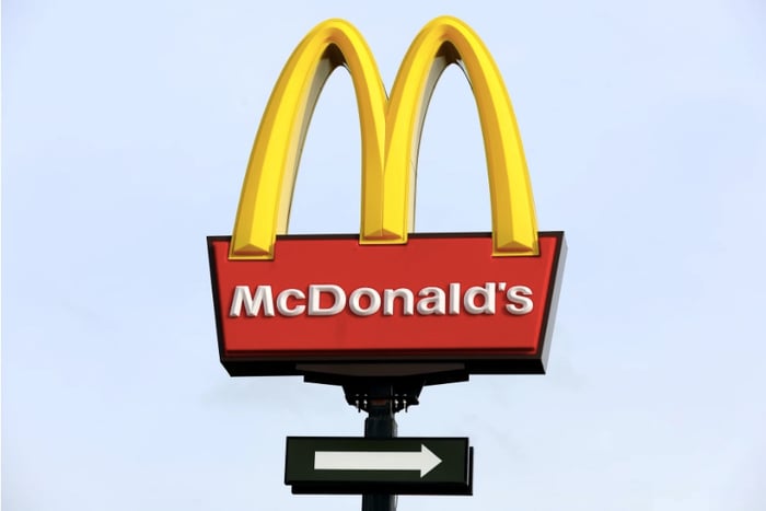 The iconic Golden Arches of McDonald's shown against a blue sky.