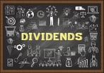 24_10_15 The word Dividends in yellow on a blackboard with doodles around it _MF Dload-1132x800-b2e72a2