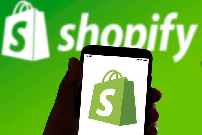 The Shopify logo on a smartphone.
