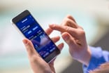 A person sumitting a stock order on a mobile device.