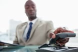Man in suit hanging up an office phone