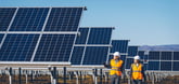 engineers walk beside rows of solar panels.-1202x569-830068e