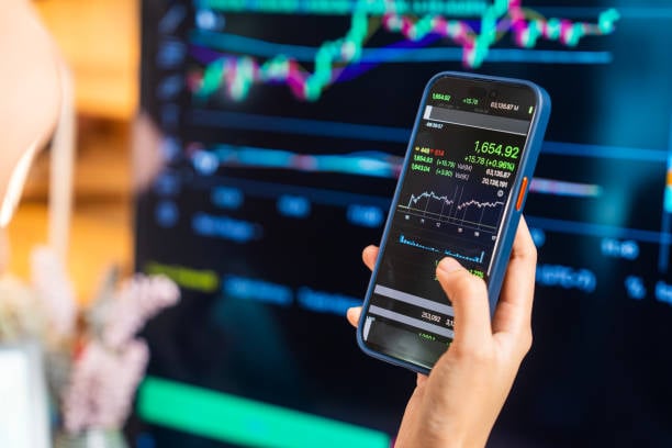 A smartphone portrays stock share prices.