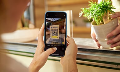 person buying plant using PayPal QR code on phone_PayPal