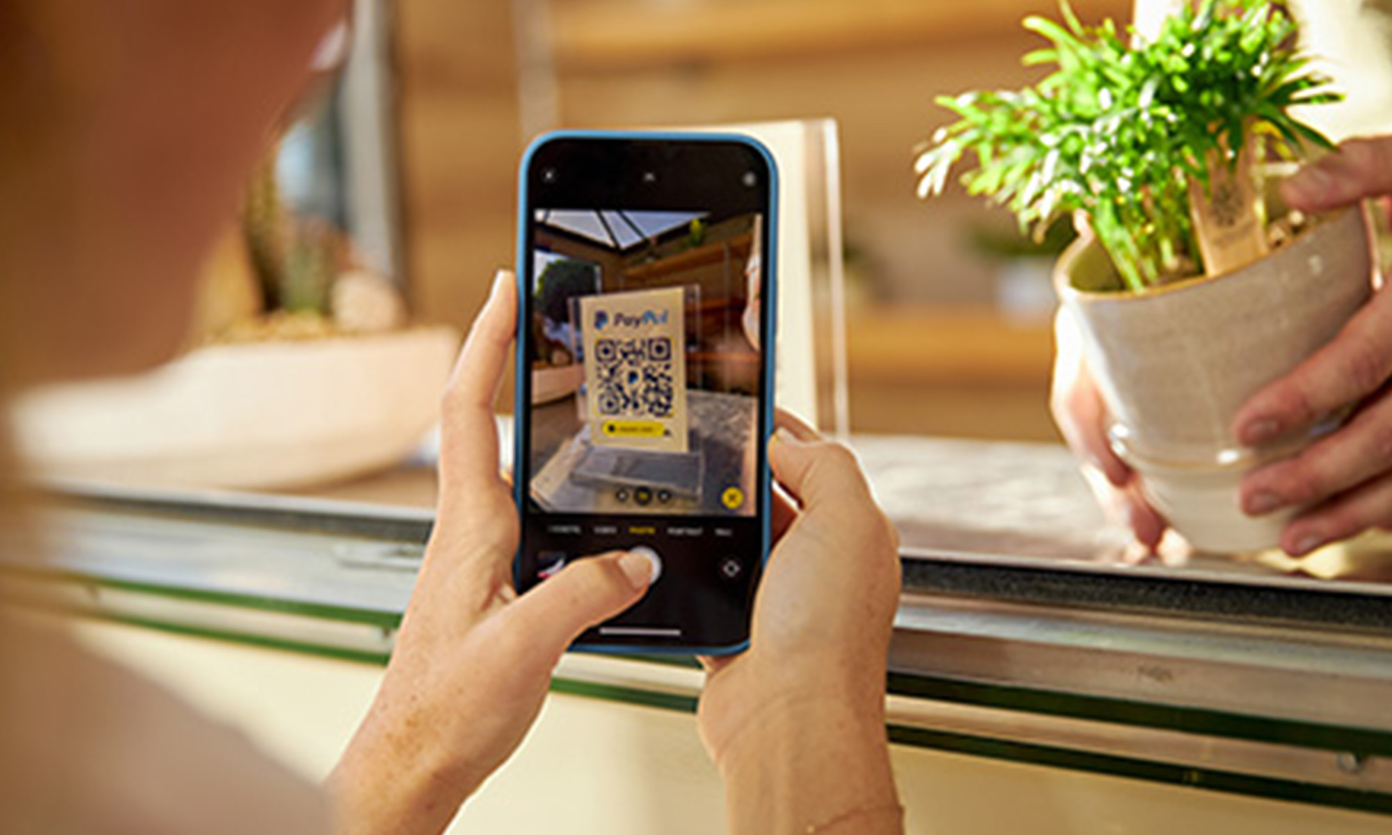 person buying plant using PayPal QR code on phone_PayPal