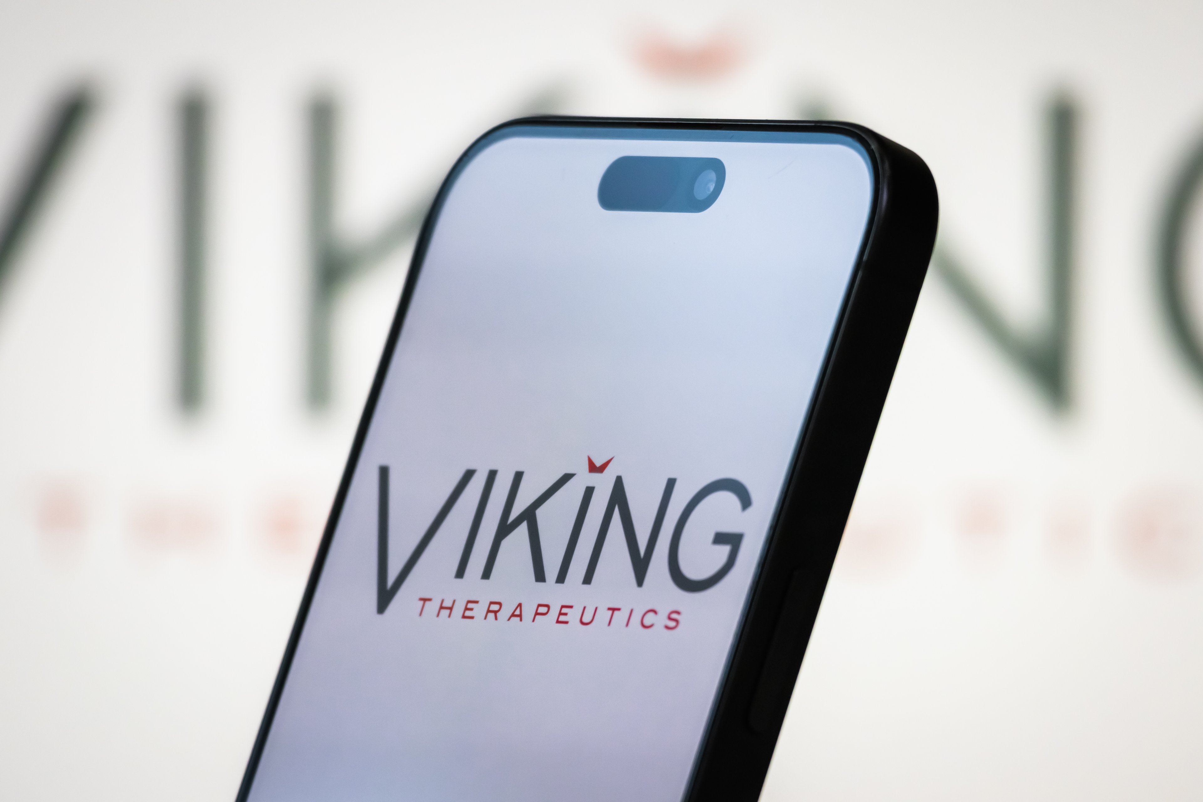viking therapeutics logo on smartphone with blurry logo background-VKTX