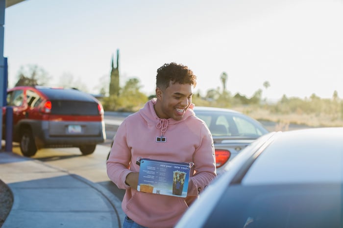 Dutch Bros worker taking drive-thru orders.